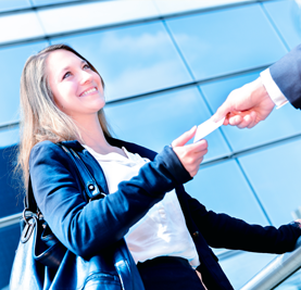 Business women passing out a business card